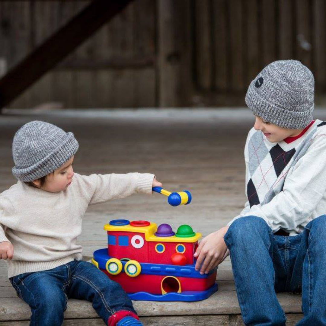 Two Kids playing with Discovery Toys Hammer Away Toy